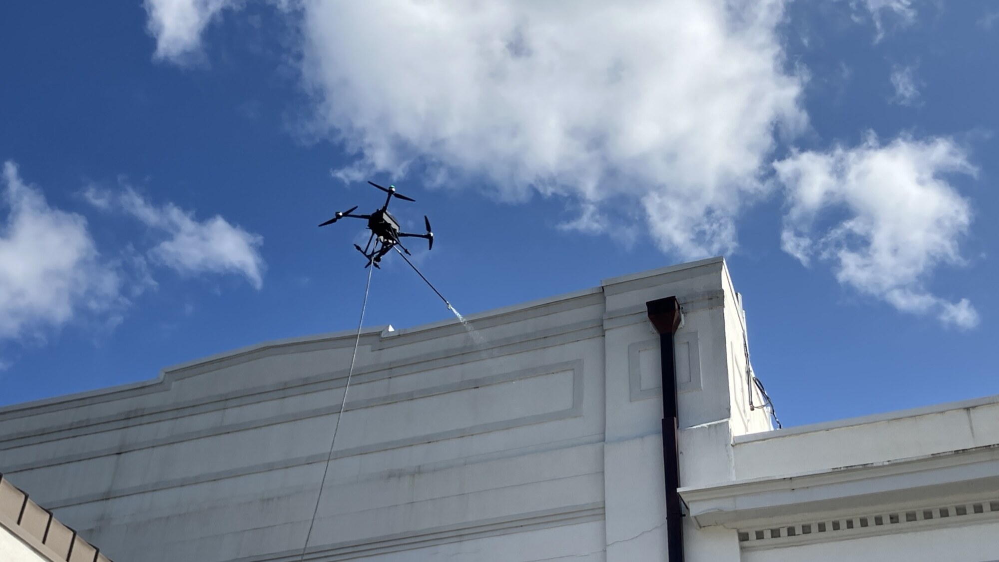 Appleton's commercial washing drone cleaning the upper facade of a courthouse