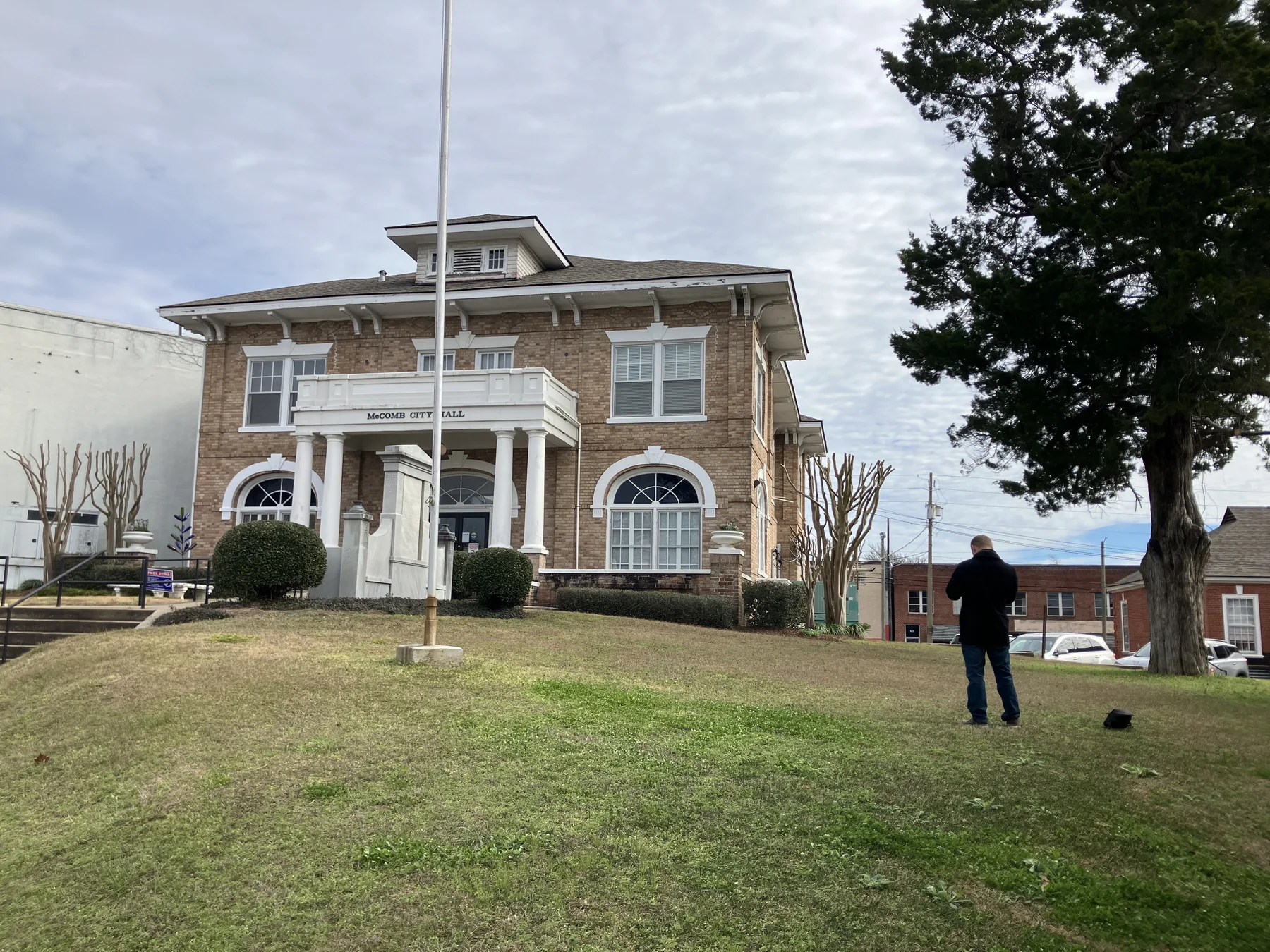 Crew member preparing to clean the exterior of a brick building