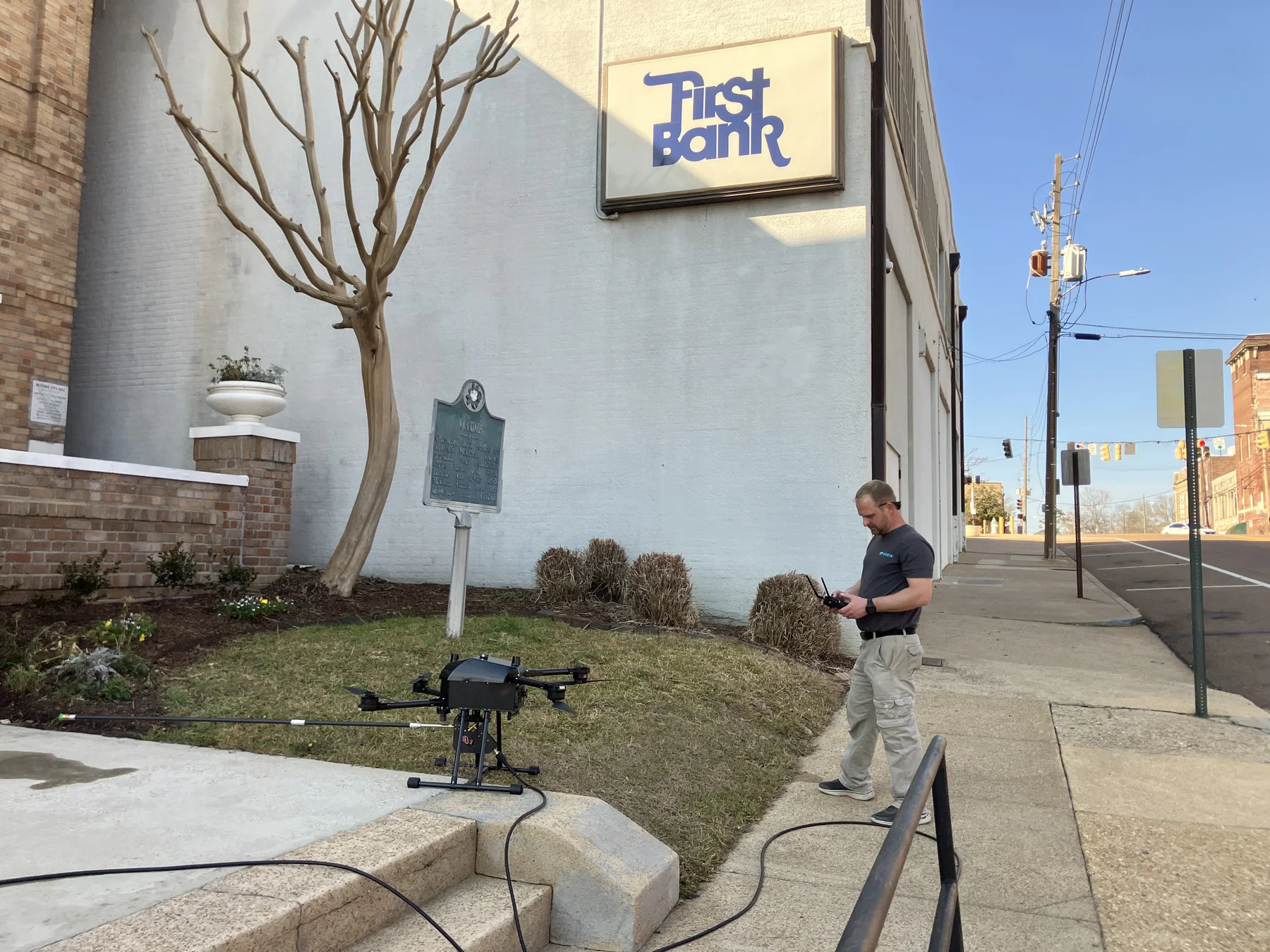 Commercial washing equipment and crew outside a storefront